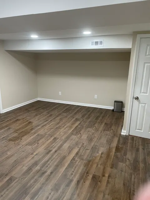 Hallway nook with new wide-plank luxury vinyl flooring and white paneled doors