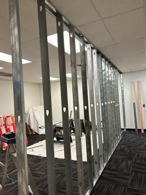Steel stud framing erected for new interior partition wall in commercial space