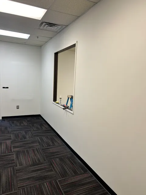 Painted partition wall with new service window opening during final trim-out