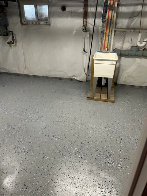 Fresh gray epoxy flake floor coating in basement utility area