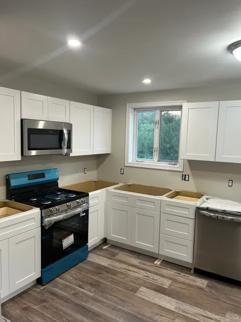 New white shaker cabinetry and stainless appliances installed during full kitchen remodel